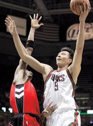 Milwaukee Bucks center Yi Jianlian of China shoots over Toronto Raptors forward Chris Bosh during the second half of an NBA basketball game Tuesday, Nov. 6, 2007, in Milwaukee.